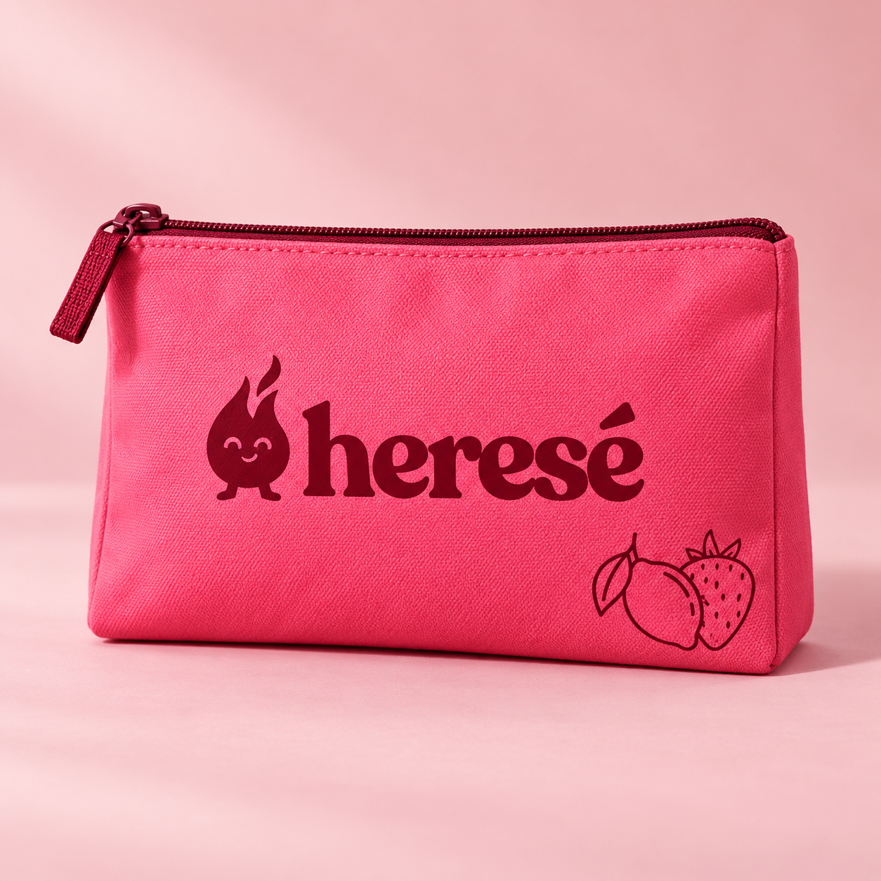 Pink Heresé zip pouch with the burgundy logo and fruit line art