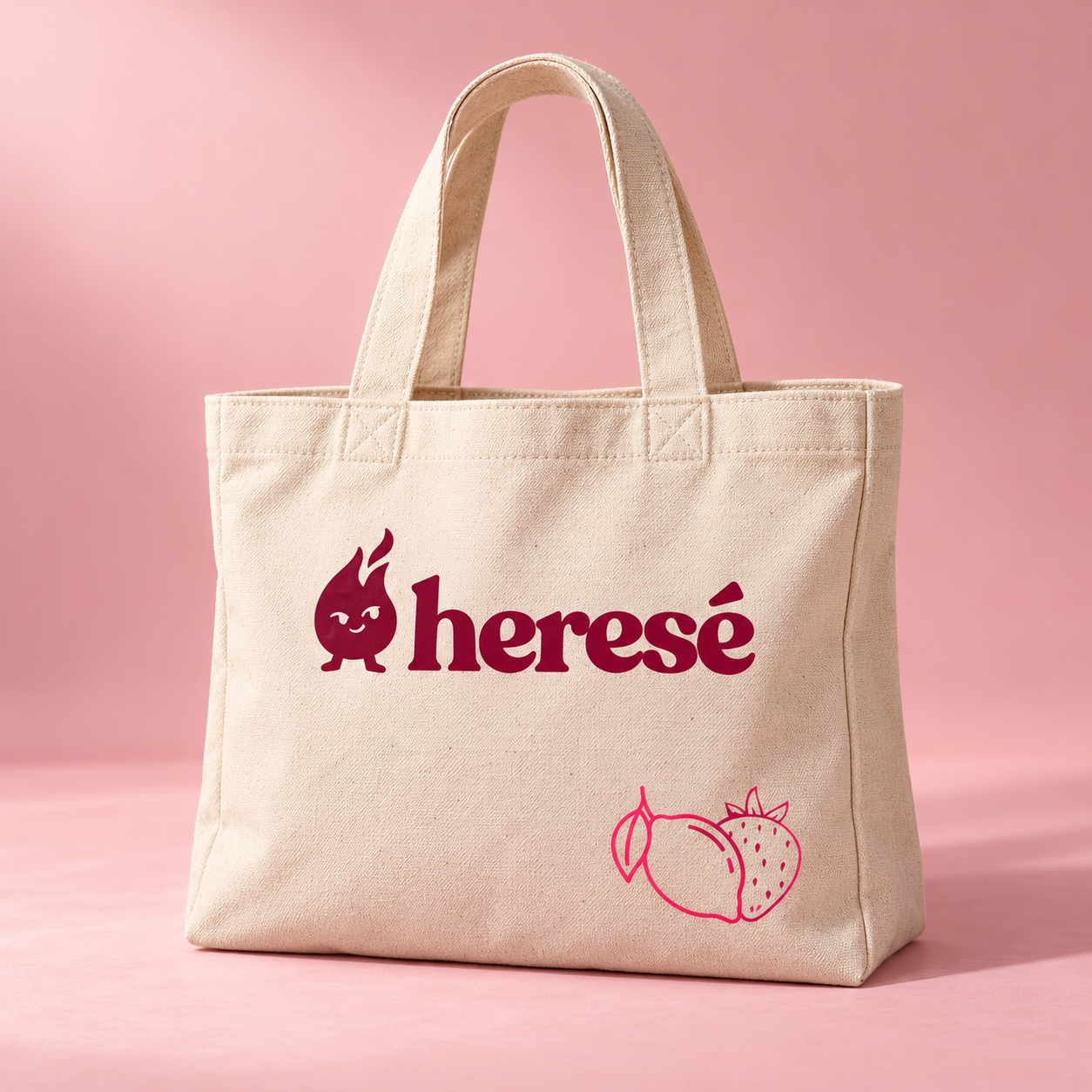 Natural canvas Heresé tote with burgundy logo and pink fruit artwork